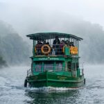 Morning boat safari in Periyar Tiger Reserve with mist and fog over the lake.
