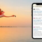 A flamingo flying over a calm lake symbolising the journey of Flemingo Routes reaching Google Page 1.