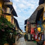A quiet historic lane with vibrant Dutch-era buildings and spice warehouses, representing hidden places in Jew Town Kochi.